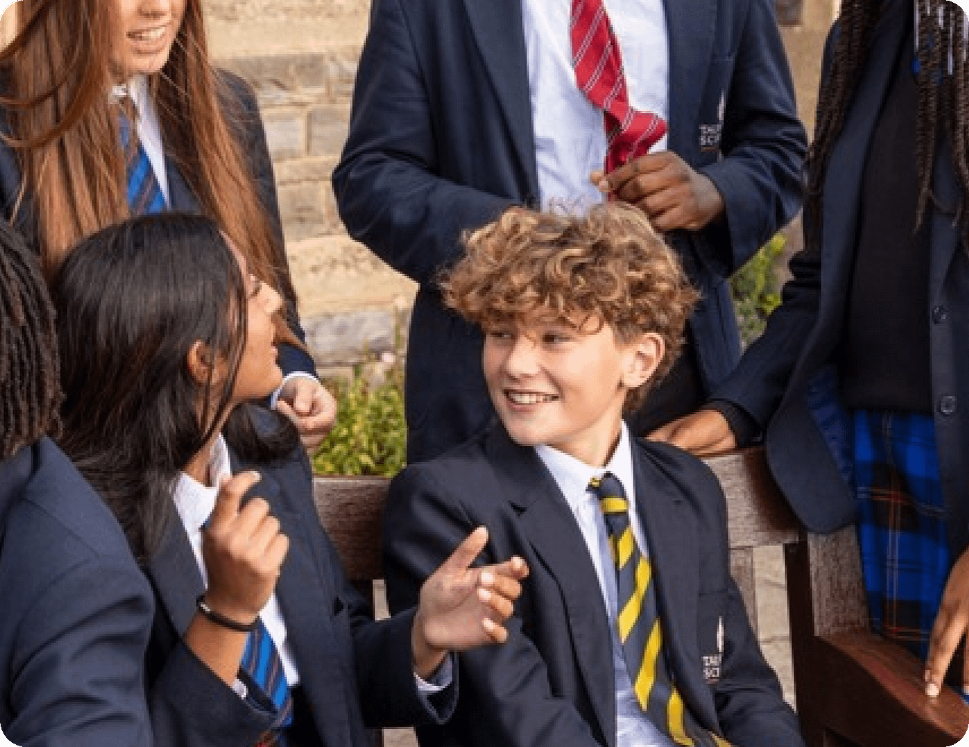 An white male student smiling and talking to a white female student